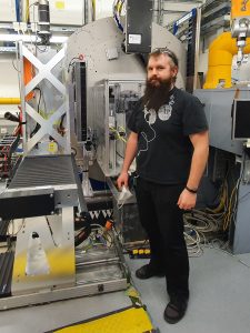 Niels at P21.1. A tall bearded man surrounded by hightech equipment.